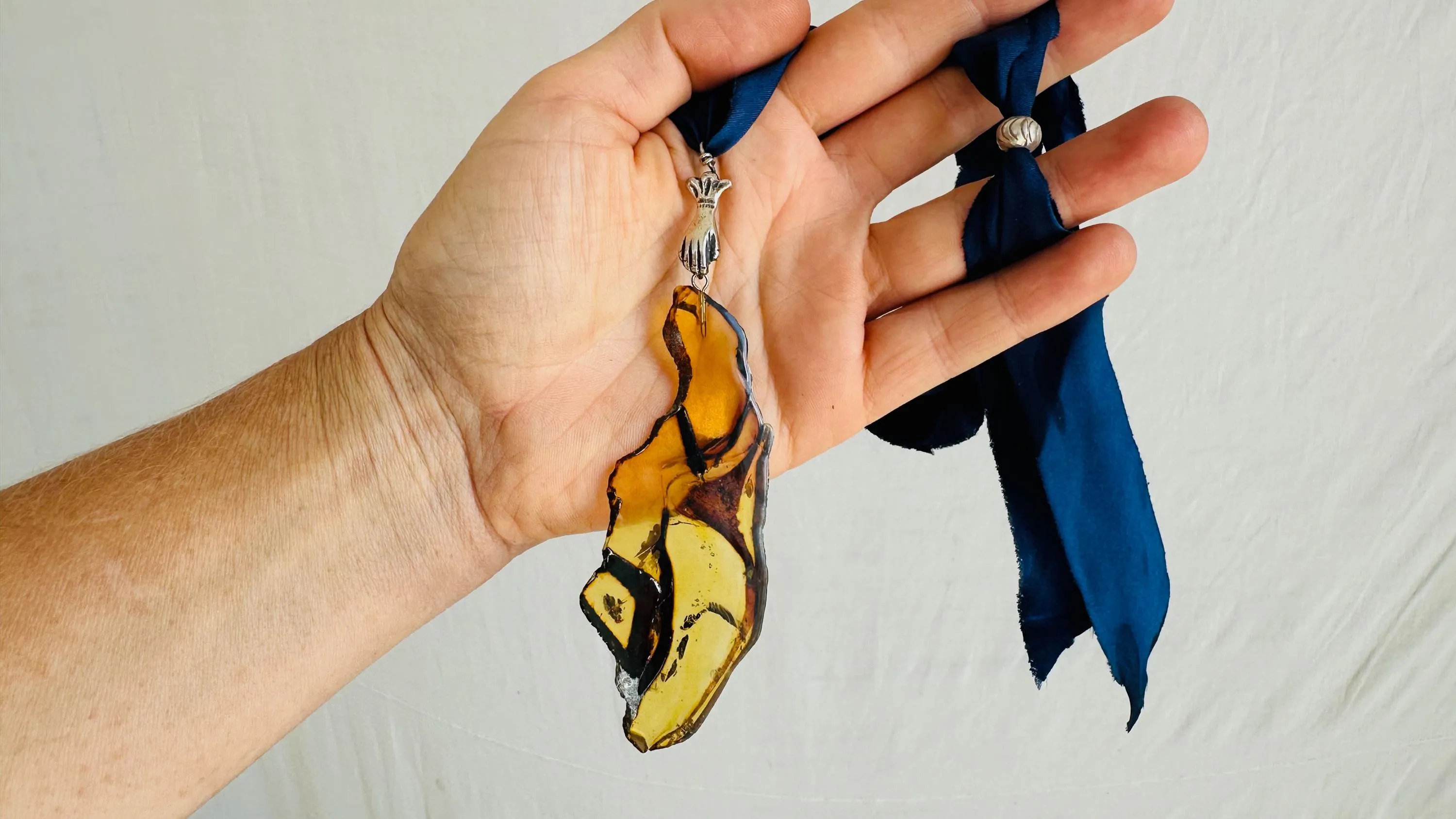 Large Amber Pendant on a Silk Ribbon. 2422